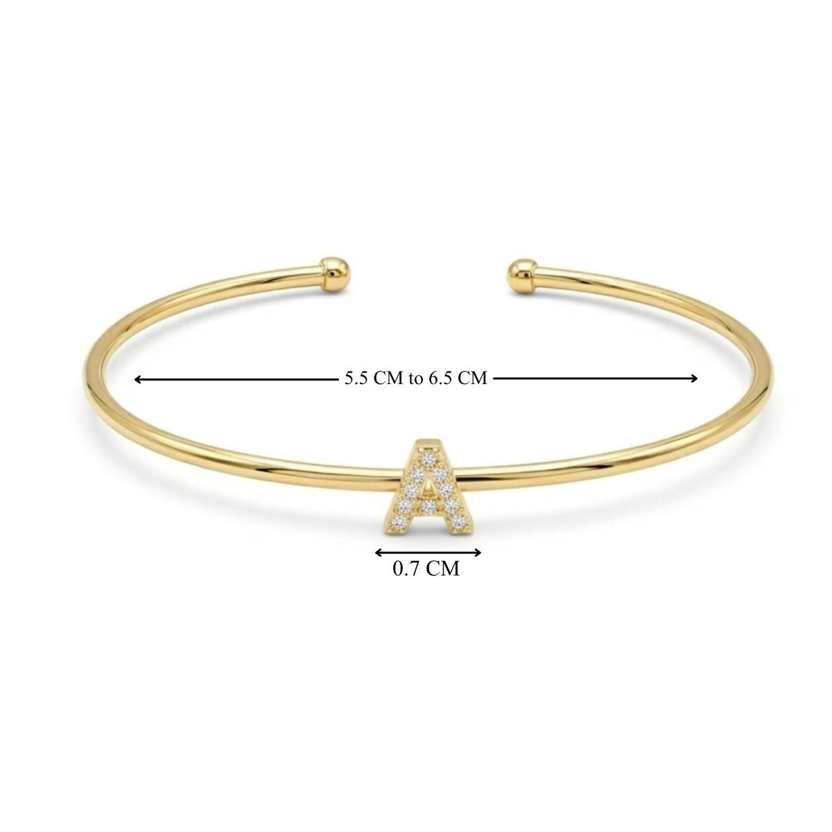 Gold open cuff bangle with a sparkling letter A charm, shown with size measurements of 5.5–6.5 cm and a 0.7 cm charm.