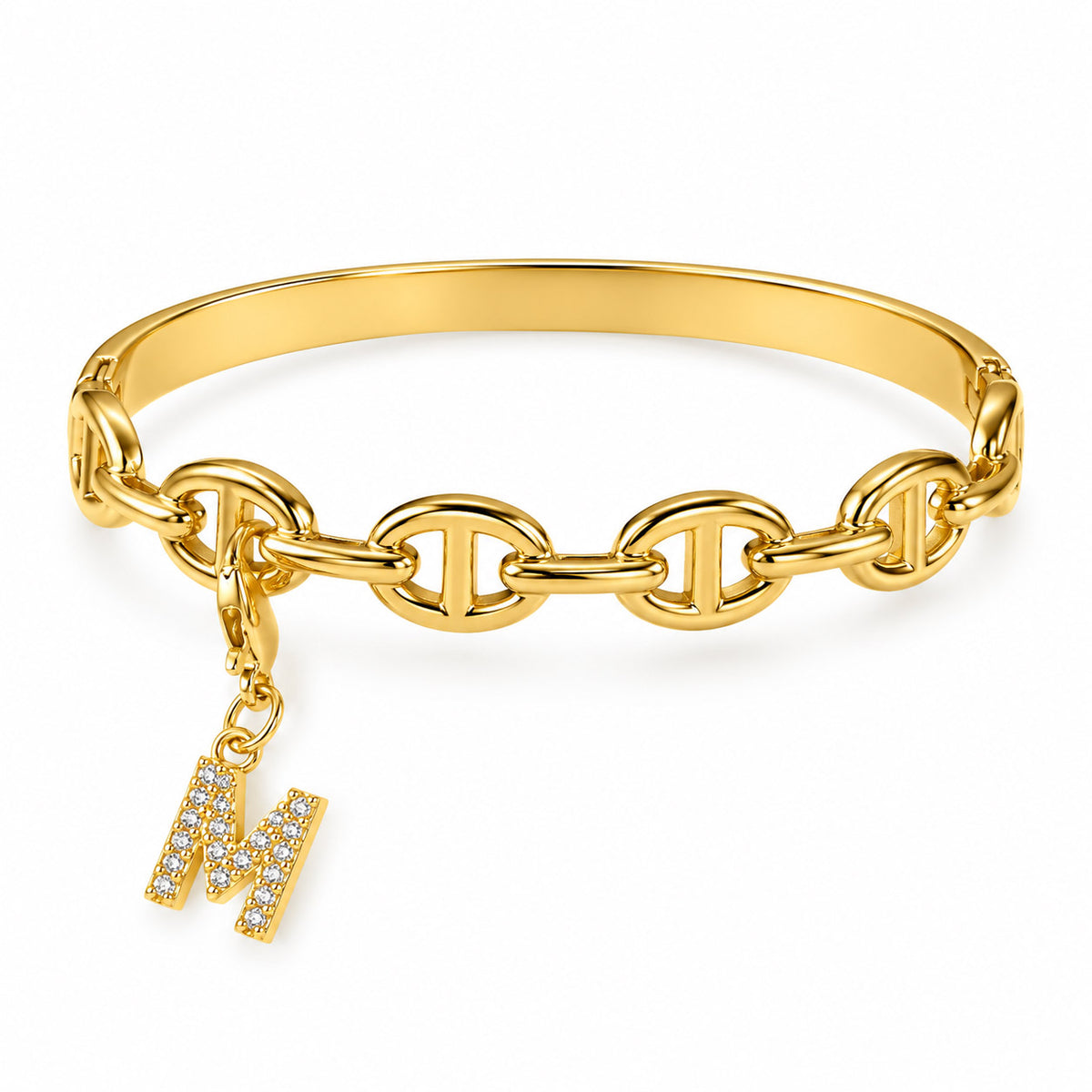 Gold-tone statement bracelet featuring linked oval chain detailing and a dangling crystal-studded letter “M” charm, displayed on a clean white background.