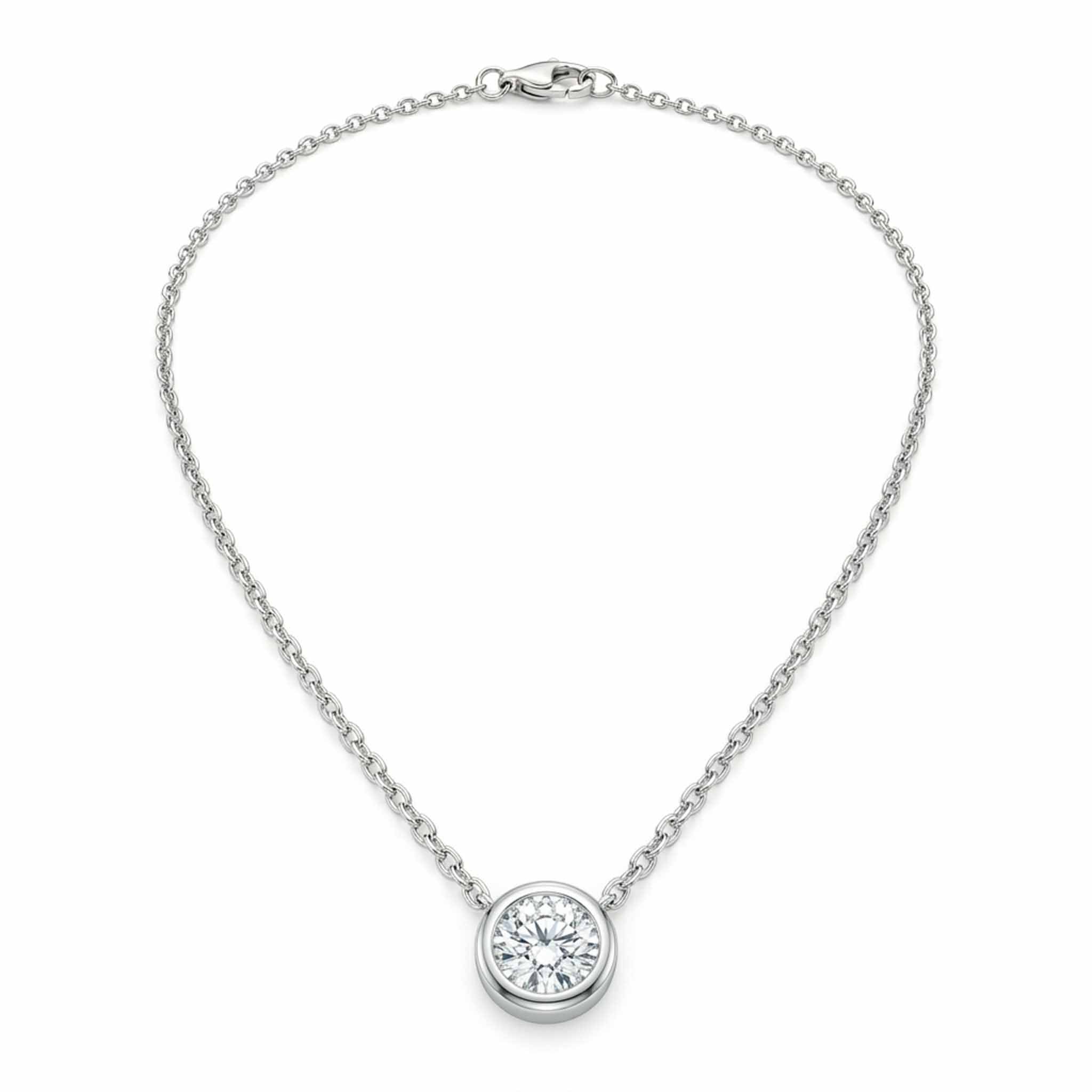 Silver solitaire pendant necklace featuring a round-cut crystal in a bezel setting on a delicate chain, displayed on a white background
