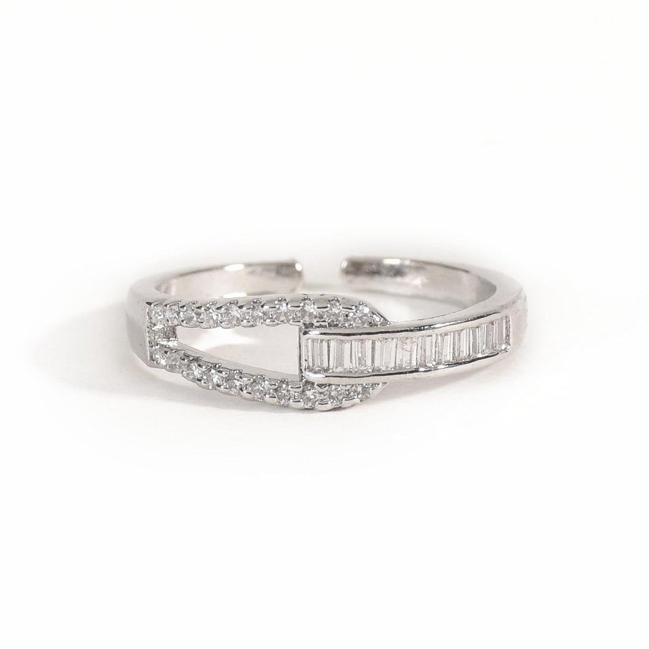 Elegant silver interlocked ring featuring baguette crystals, pavé detailing, and an anti-tarnish finish, perfect for modern styling, statement looks, and everyday sophistication.