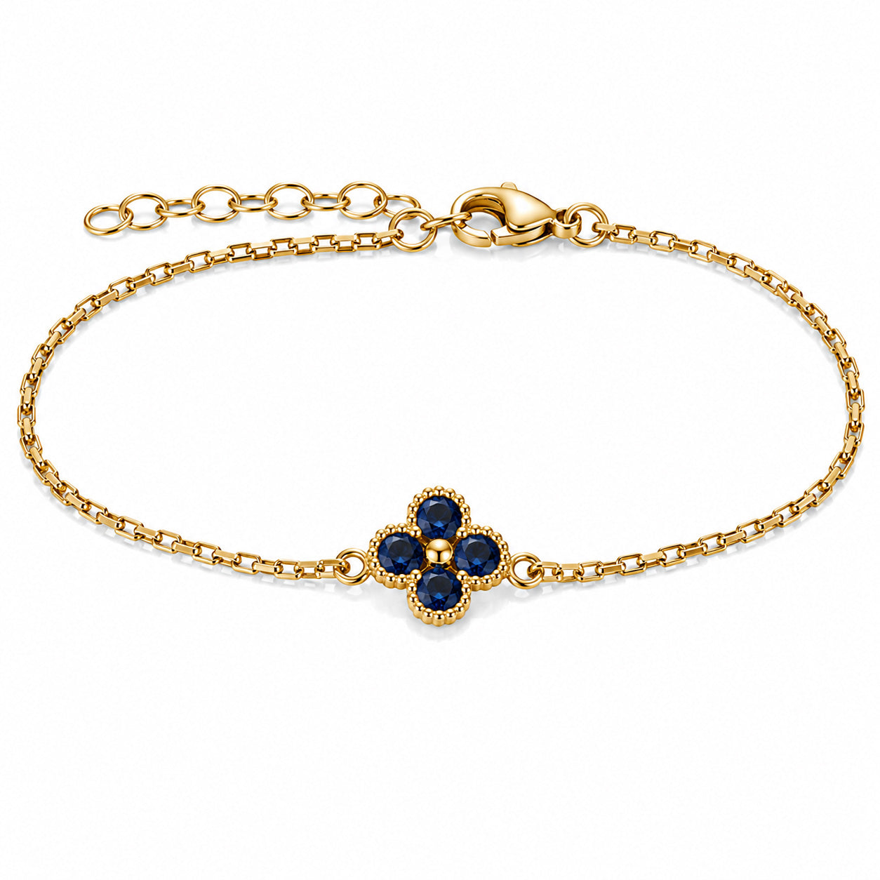 Gold-tone bracelet featuring a blue four-petal flower charm with faceted stones, a delicate link chain, and an adjustable clasp on a white background.