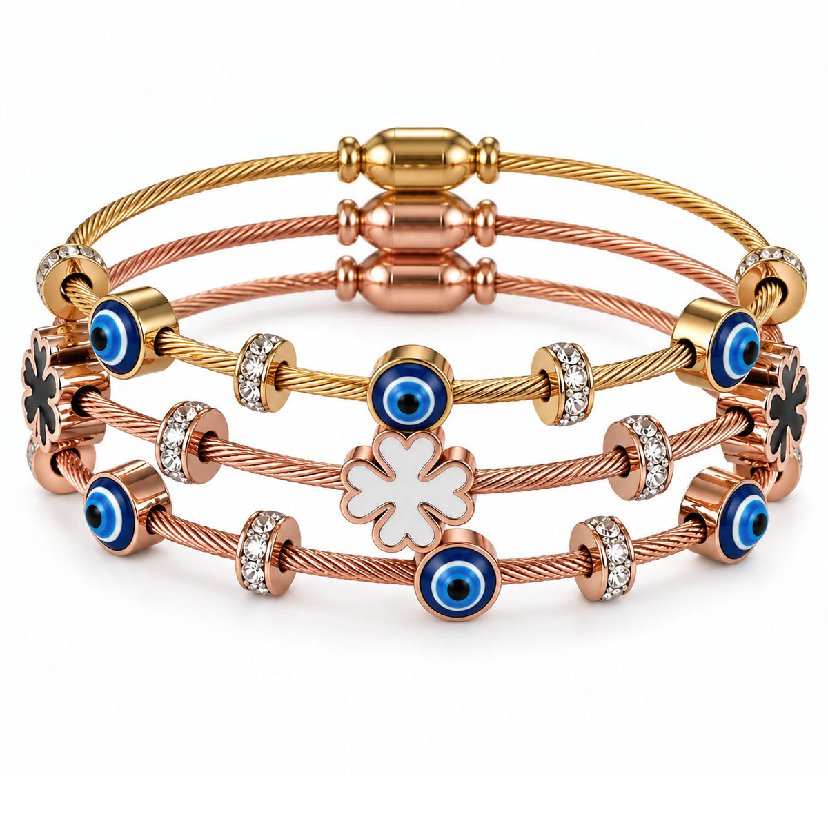 A product photo of a stacked set of mixed-metal twisted cable wire bracelets featuring gold and rose gold finishes, adorned with blue-and-white evil eye charms, sparkling rhinestone spacers, black clover accents, and a central white mother-of-pearl clover pendant.