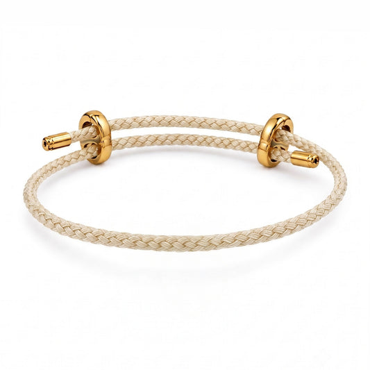 Braided Pink cord bracelet with gold-tone sliding rings and end caps on a white background.