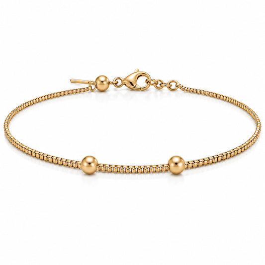 Gold chain bracelet with three polished gold bead accents and adjustable clasp on a white background.