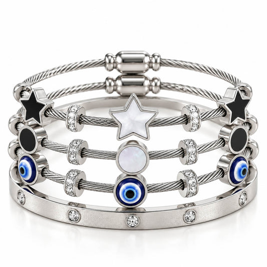 A product photo of a stacked set of silver-tone bracelets featuring twisted cable wire bands, star and circular mother-of-pearl stations, black enamel accents, blue-and-white evil eye beads, and a crystal-set bangle.