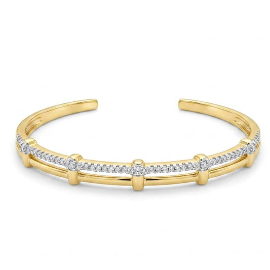 Anti-tarnish yellow gold open cuff bracelet featuring a dual-strand design with an upper pavé cubic zirconia row joined to a smooth bottom band by vertical gold bars,on a white background .