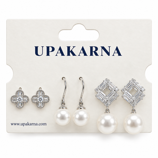 Silver earring set displayed on a white jewellery card, featuring crystal flower studs, pearl drop earrings, and geometric crystal pearl earrings.