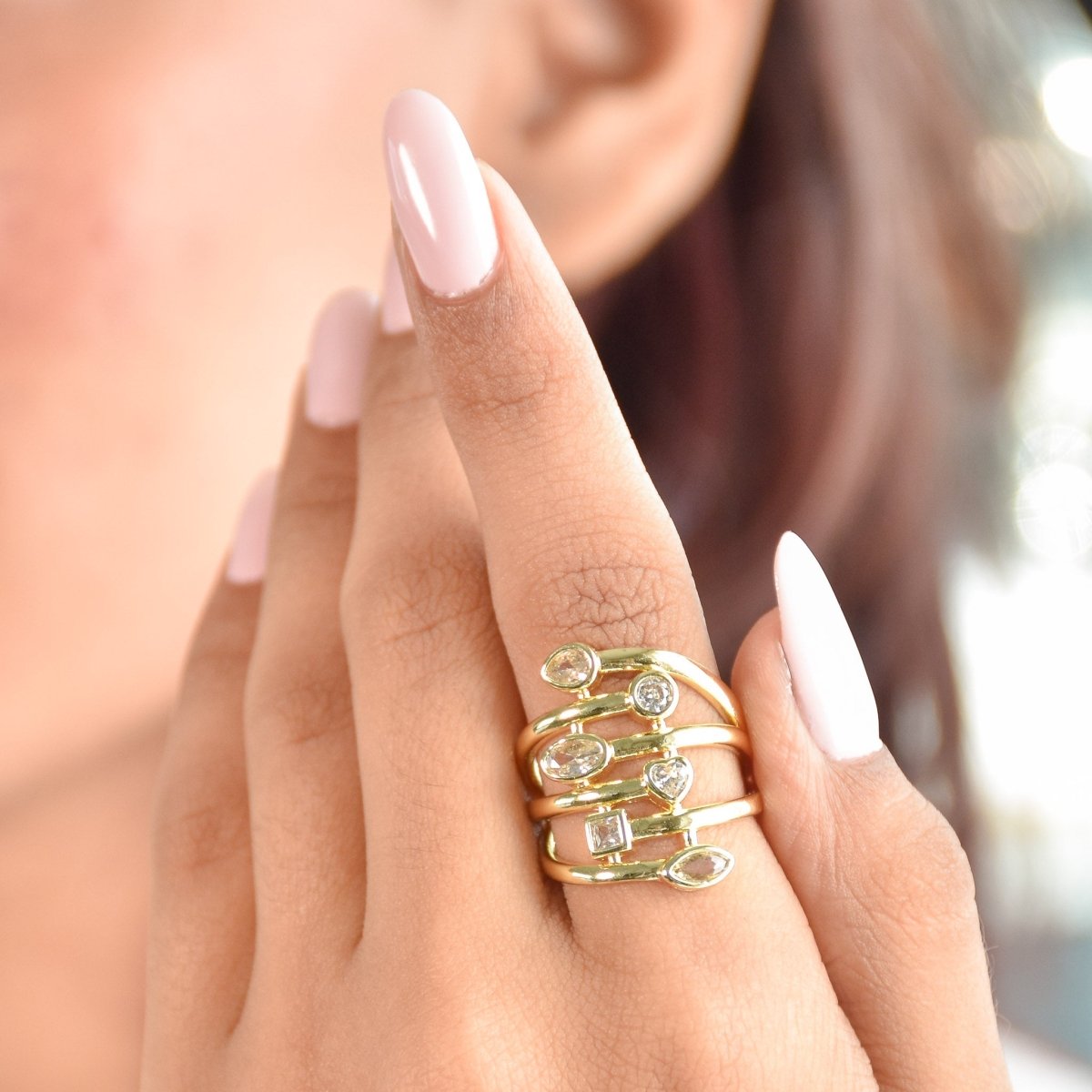 Bold golden spiral ring with mixed-cut crystal detailing and an adjustable anti-tarnish finish, perfect for statement styling, parties, brunch looks, and festive glam.