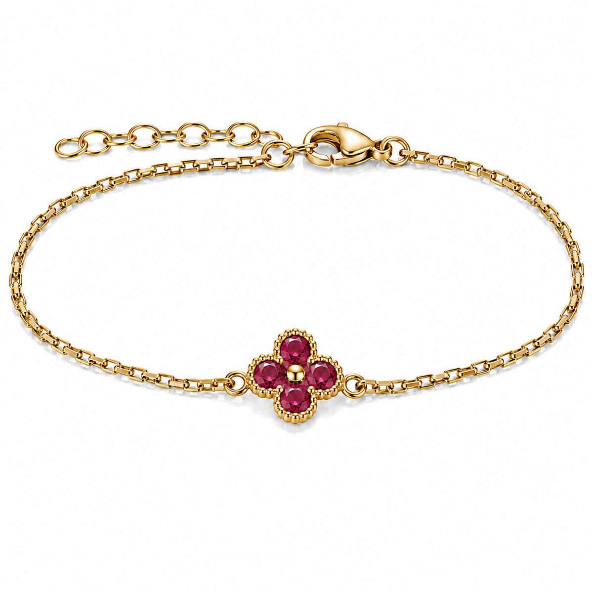 Gold-plated bracelet featuring a delicate four-leaf clover charm with four deep ruby-red stones, set on a fine gold chain with an adjustable extension chain and lobster clasp, displayed against a clean white background.