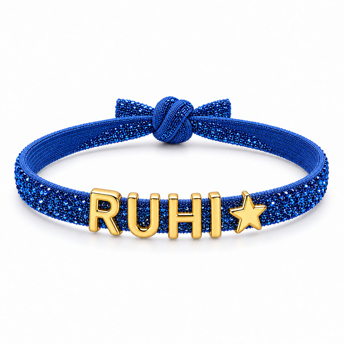 Blue glittery adjustable bracelet featuring a knot detail and gold-tone RUHI letter charms with a star charm at the end.