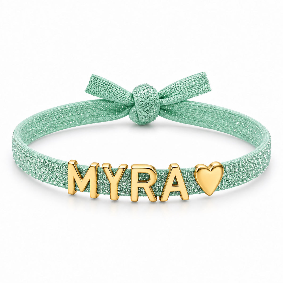 Mint-green glittery adjustable bracelet featuring a bow detail and gold-tone MYRA letter charms with a heart charm at the end.