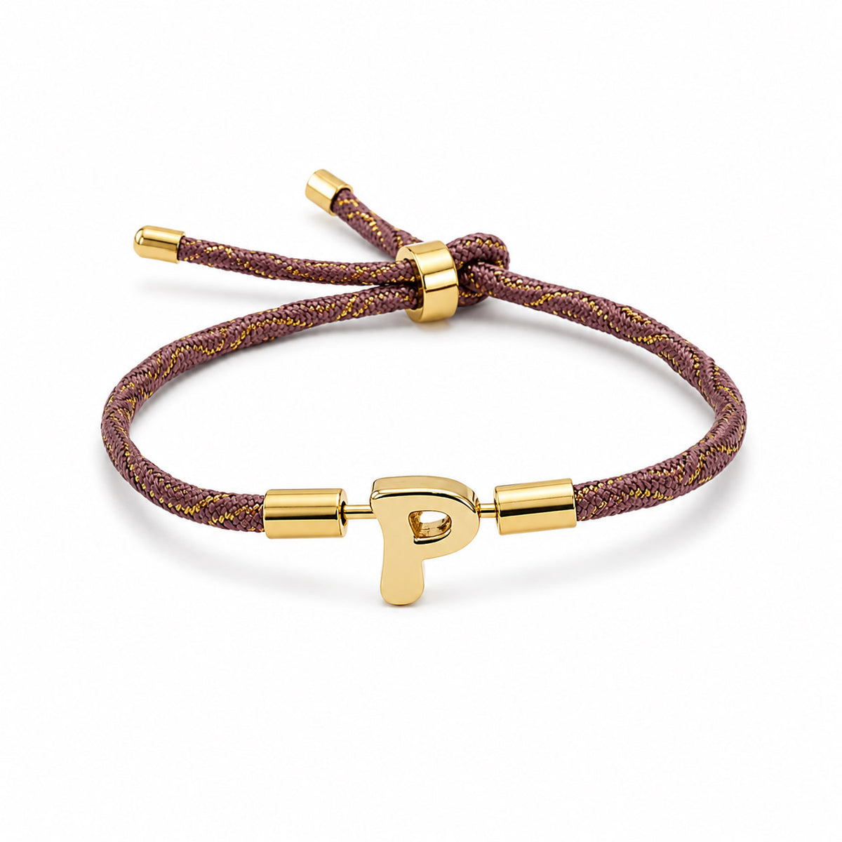 Gold-tone personalized initial “P” charm bracelet with a brown braided cord featuring subtle gold detailing and an adjustable sliding closure, displayed on a clean white background.