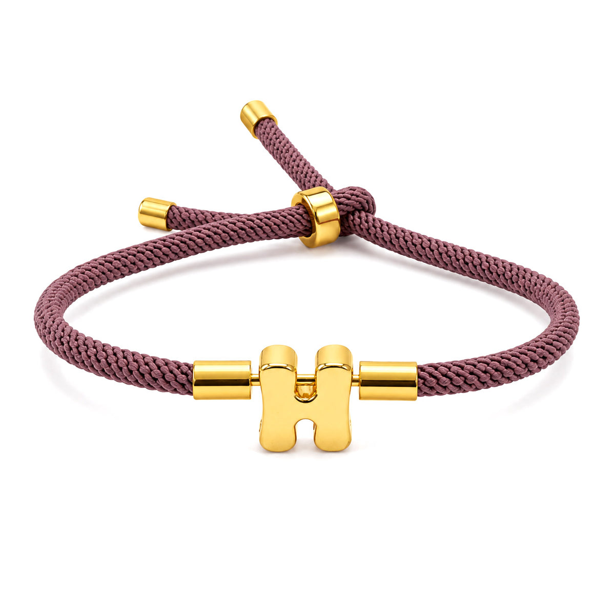 Gold-tone personalized initial “H” charm bracelet with a dusty rose braided cord, polished gold accents, and an adjustable sliding closure, displayed on a clean white background.