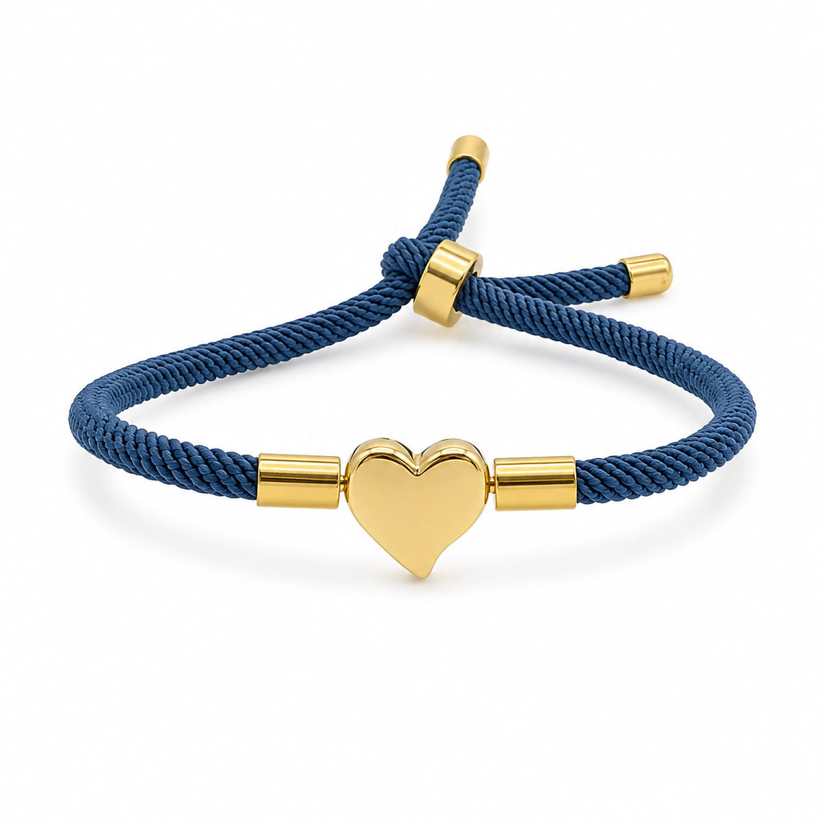 Gold-tone heart charm bracelet with a navy blue braided cord, polished gold accents, and an adjustable sliding closure, displayed on a clean white background.