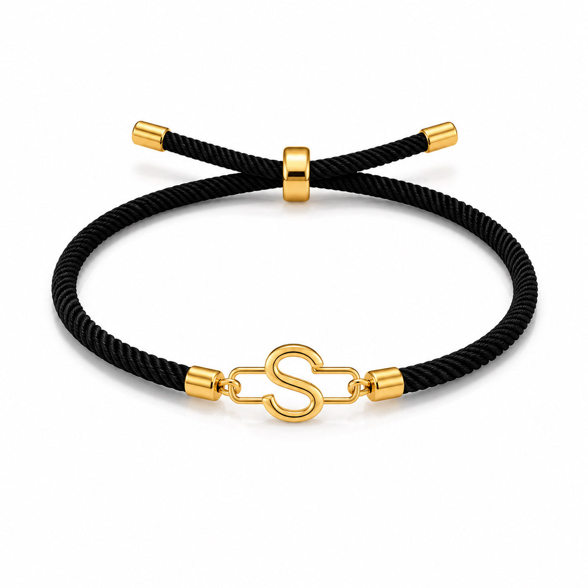 Black braided cord bracelet with a gold tone letter S charm, gold tone end caps, and an adjustable sliding clasp, displayed on a white background.