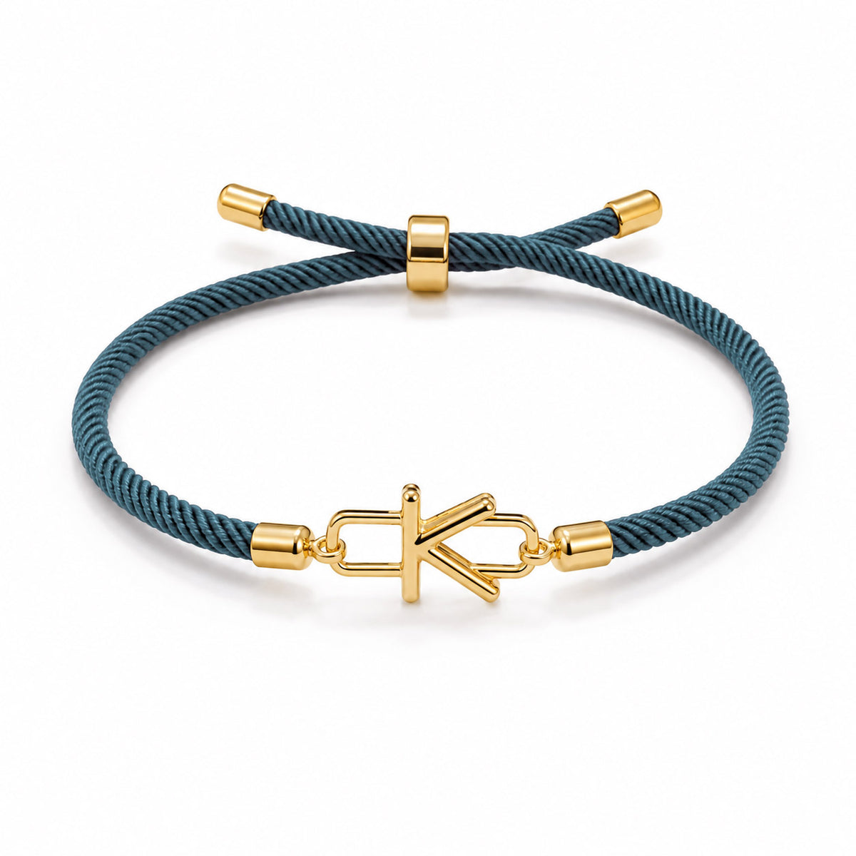 Blue braided cord bracelet with gold-tone end caps and a gold-tone letter K charm, displayed on a white background.