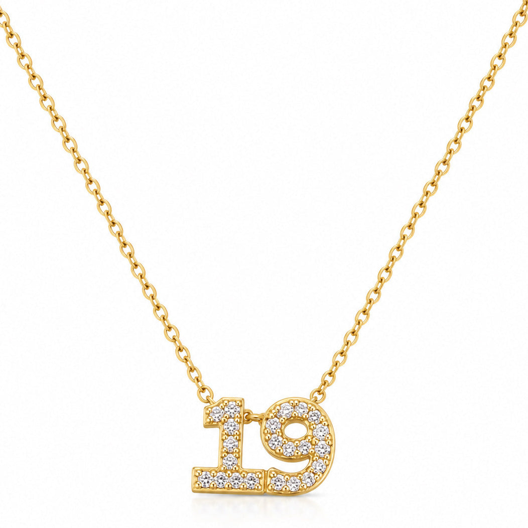 Gold-plated personalized number necklace featuring a sparkling pavé “19” pendant on a delicate gold chain, displayed against a clean white background.