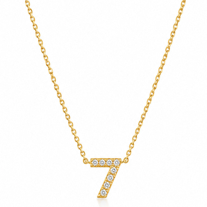 Gold-plated personalized number necklace featuring a sparkling pavé “7” pendant on a delicate gold chain, displayed against a clean white background.