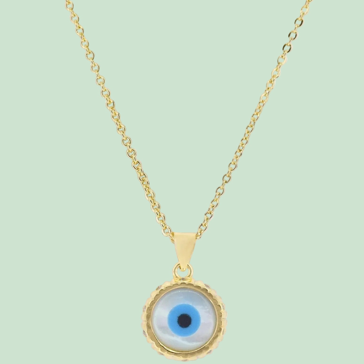 Gold necklace with an eye-shaped pendant on a white background