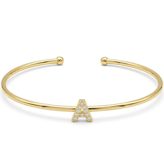 Elegant gold-tone adjustable open cuff bangle featuring a pavé crystal-studded letter A centerpiece. The personalized initial bangle has a sleek polished finish with rounded ball ends and is displayed on a clean white background, making it perfect for everyday wear, stacking, gifting, and personalized jewellery collections.