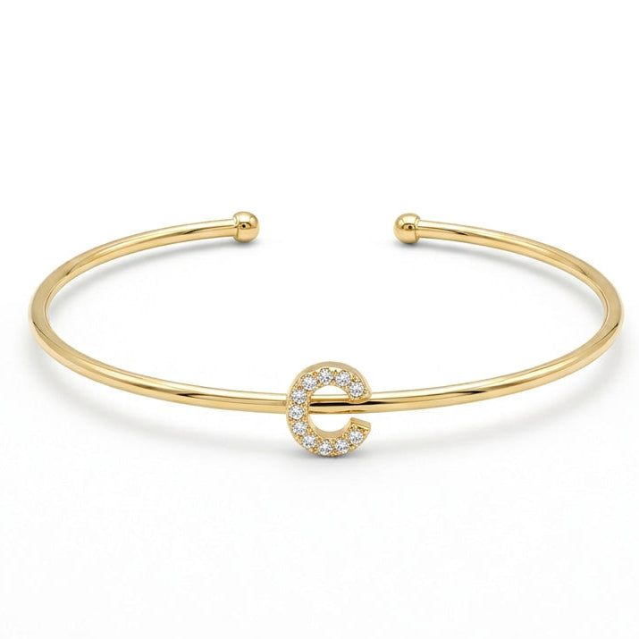 Elegant gold-tone adjustable open cuff bangle featuring a pavé crystal-studded letter C centerpiece. The personalized initial bangle has a sleek polished finish with rounded ball ends and is displayed on a clean white background, making it perfect for everyday wear, stacking, gifting, and personalized jewellery collections.