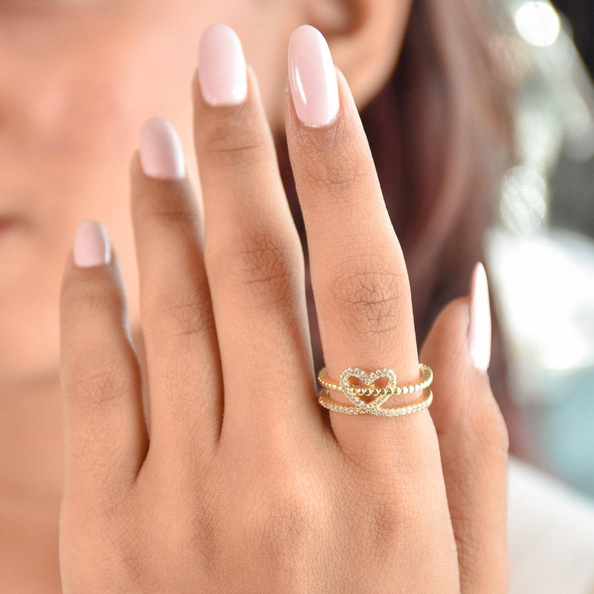 Elegant golden heart ring with twin-band detailing, sparkling pavé accents, and an adjustable anti-tarnish finish, perfect for soft glam styling, everyday elegance, and thoughtful gifting.