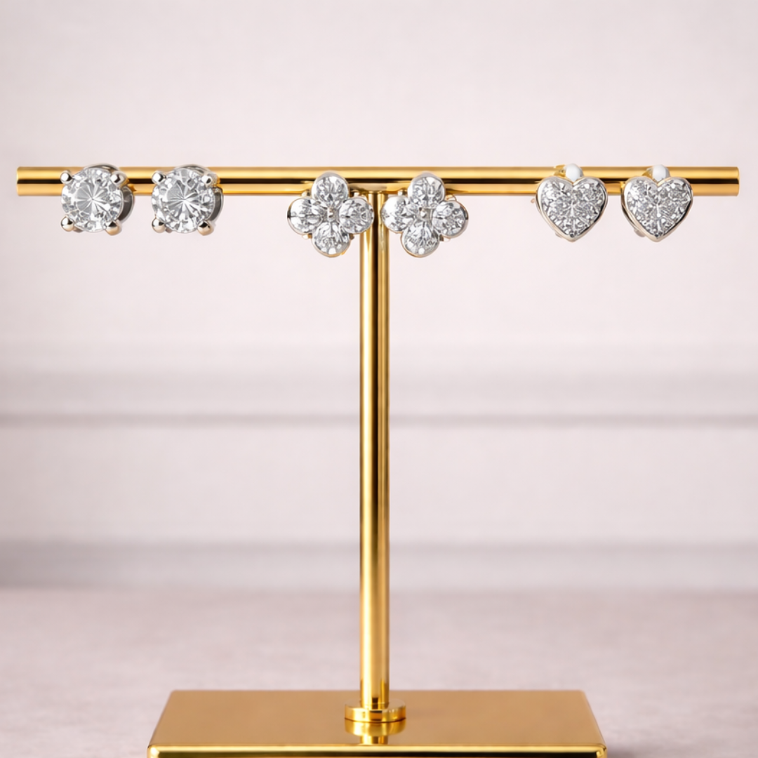 Diamond stud earring stack with heart studs, clover studs, and single stone studs in silver-tone finish
