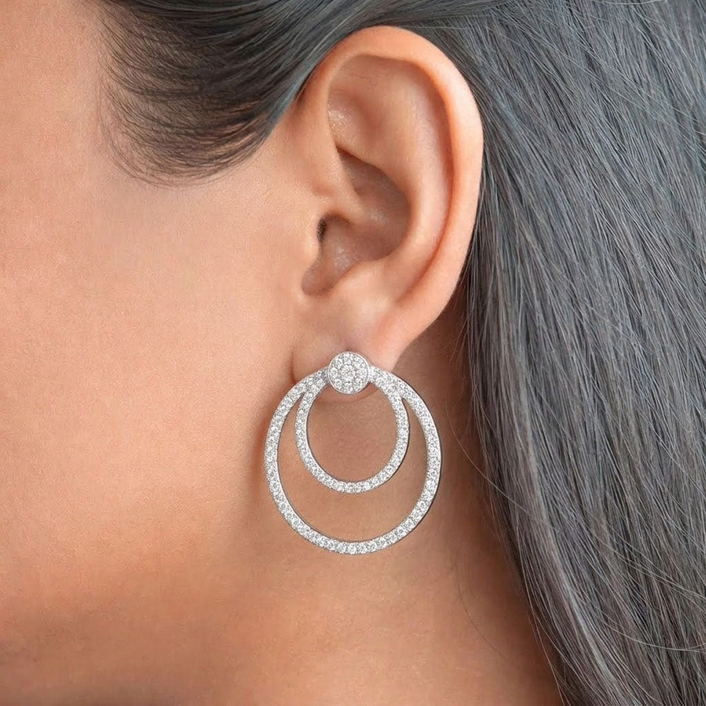 Double Orbit 925 Sterling Silver Earrings featuring two interlocking pave-set circular hoops adorned with shimmering cubic zirconia stones