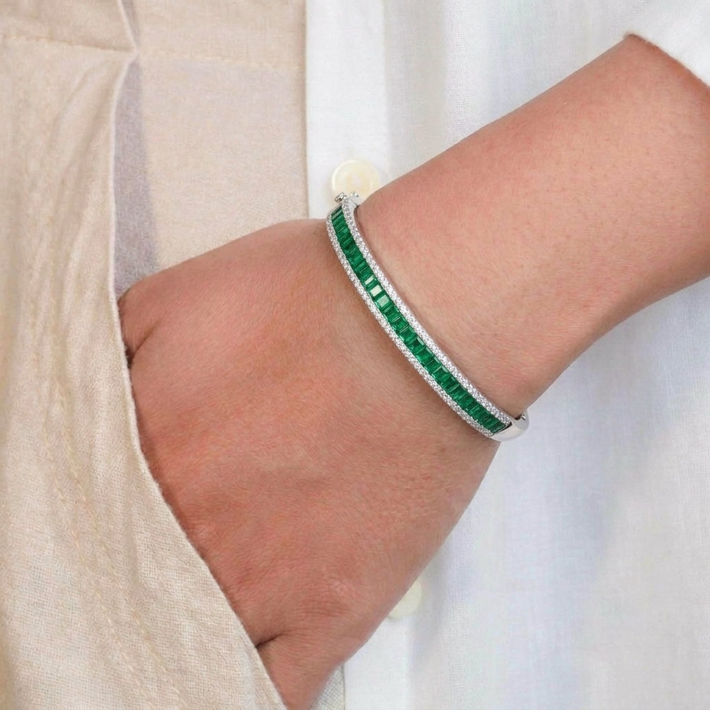 Emerald Cascade 925 Sterling Silver Bangle with emerald-green baguette stones, shimmering cubic zirconia borders
