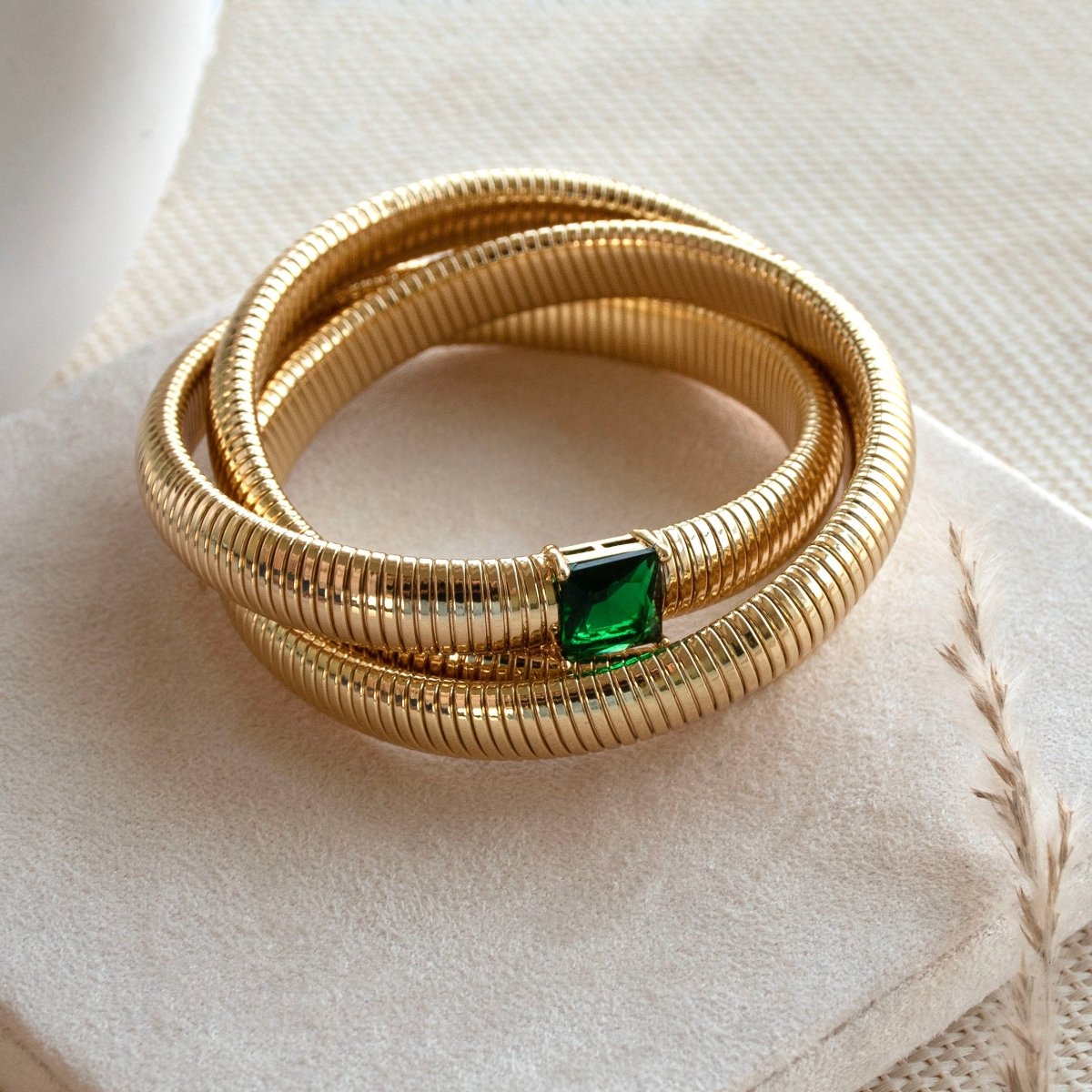 Elegant triple-layer bangles with vibrant emerald stone detailing and an anti-tarnish finish, perfect for party wear, casual elegance, and royal-inspired styling.