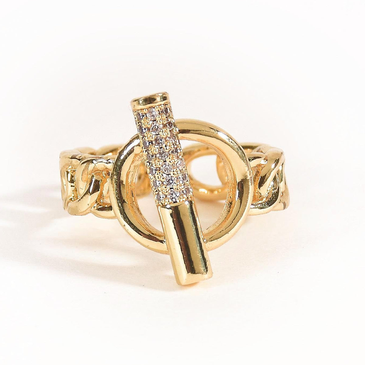 A stack of three adjustable gold-toned rings: a sculptural spike spiral, a chunky chain-link band, and a central signet ring featuring an evil eye symbol.