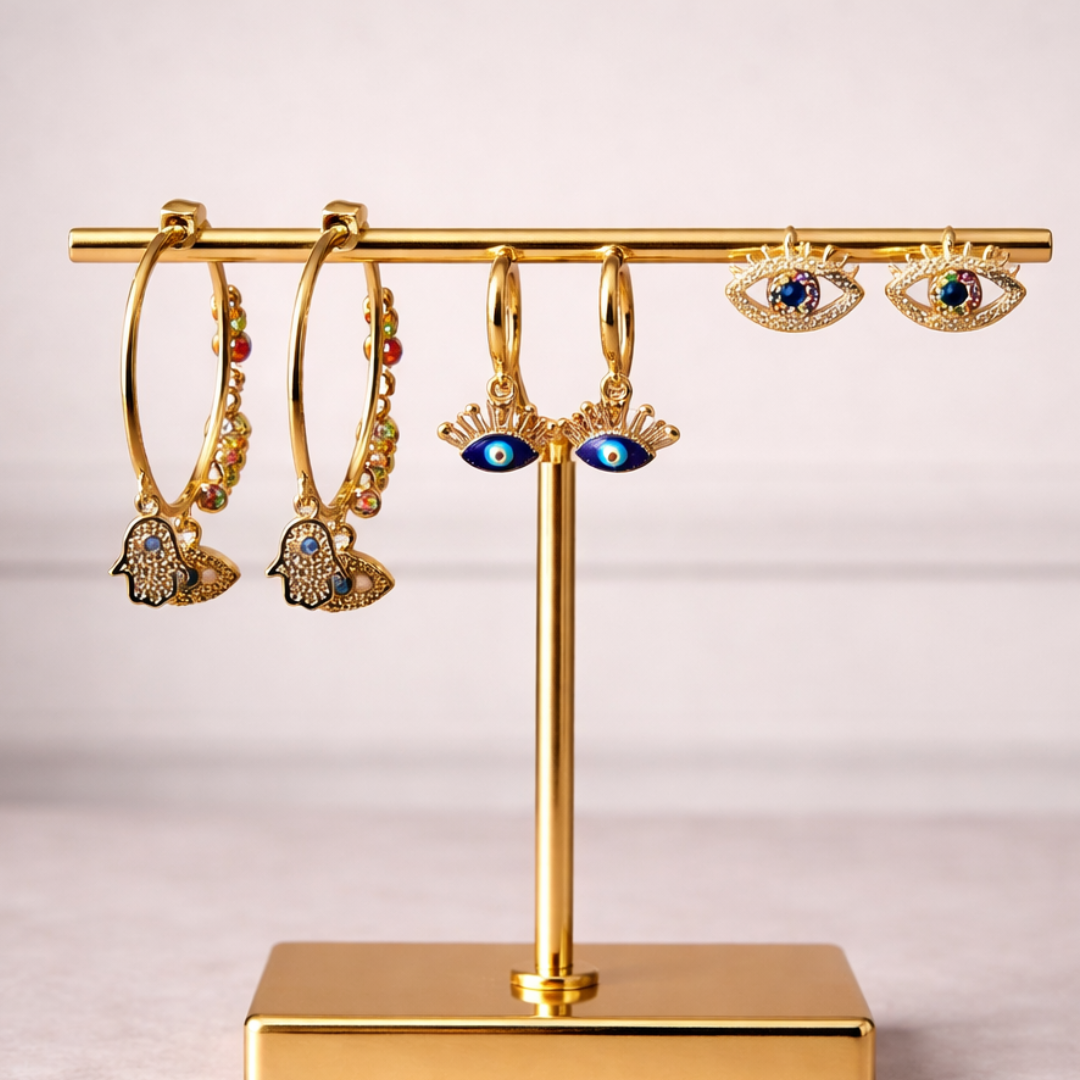 Evil eye earrings set featuring crystal stud, gold hoop with eye charm, and lash design statement earrings
