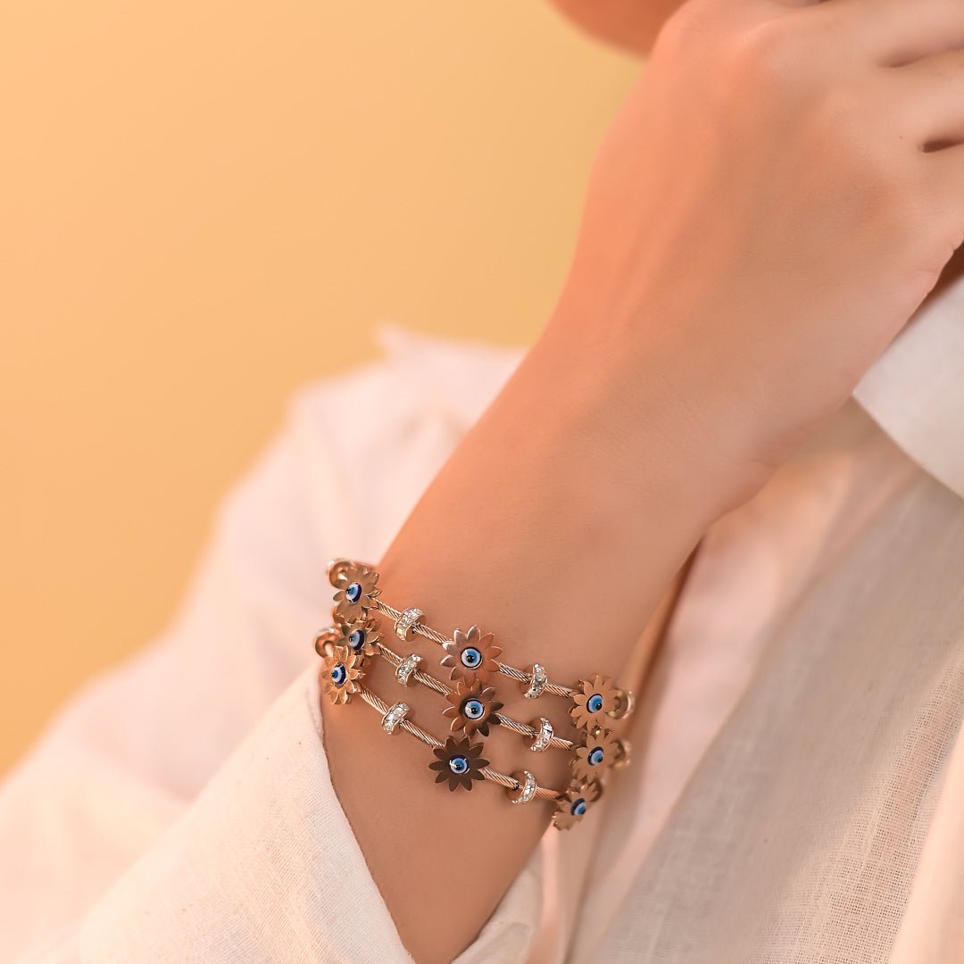 Elegant rosegold evil eye bangle with floral detailing, a secure magnetic lock, and an anti-tarnish finish, perfect for everyday wear, parties, and chic versatile styling.