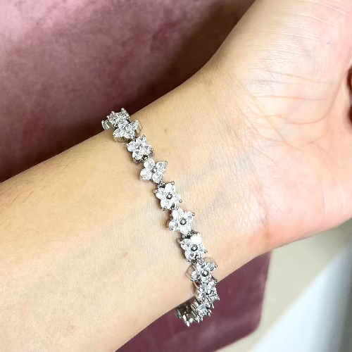 Flower tennis bracelet with sparkling floral crystal detailing and an anti-tarnish silver finish, perfect for everyday wear, elegant styling, and special occasions.