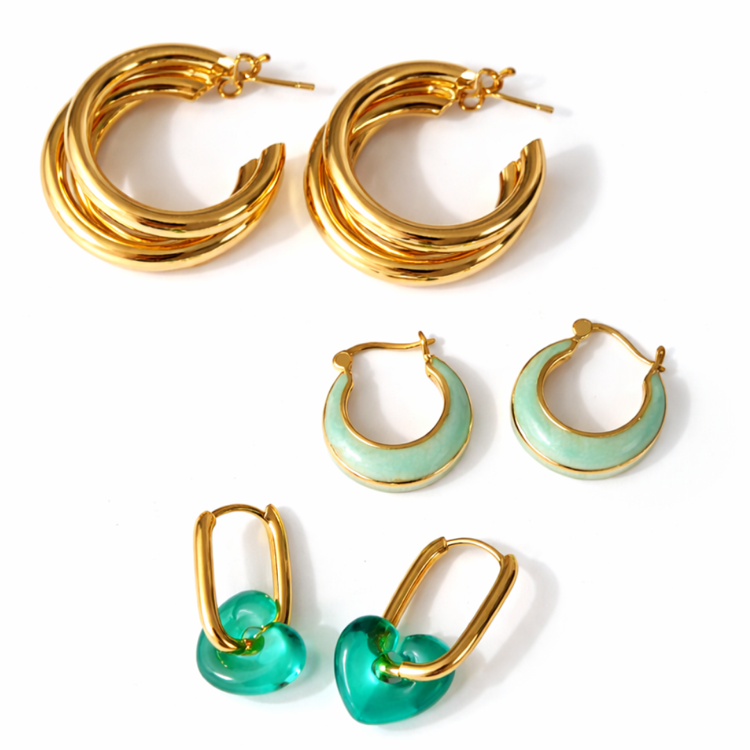 Three-pair earring stack featuring chunky gold triple hoops, sage green enamel hoops, and gold hoops with translucent seafoam-green resin heart charms.