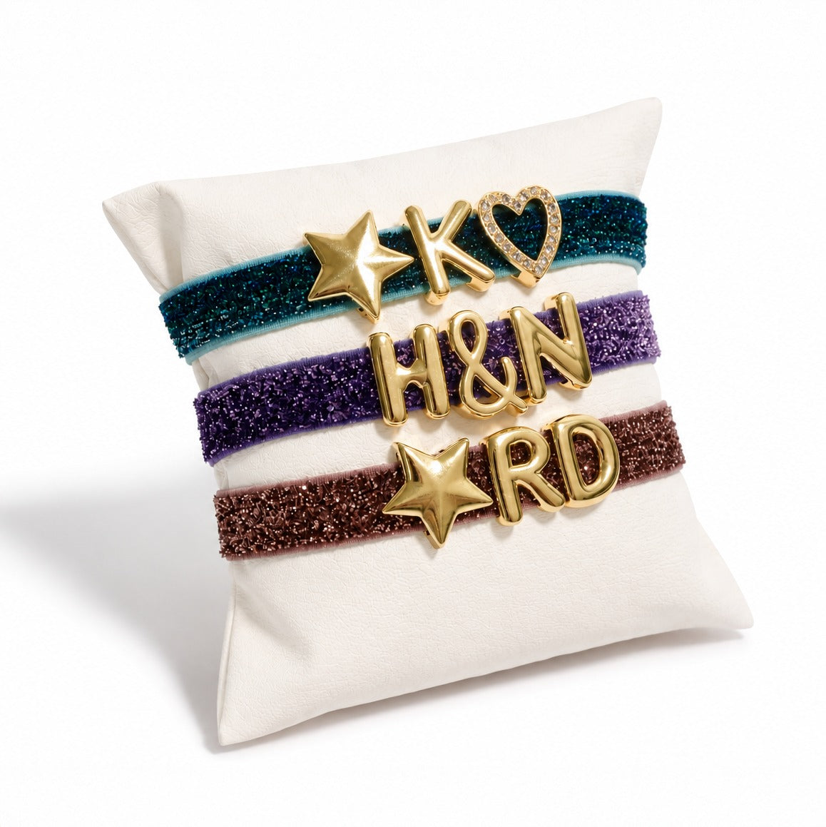 Glitter Glow Adjustable Band with personalised letter charms in grey, ink blue, brown, dark pink, purple and green glitter colours.