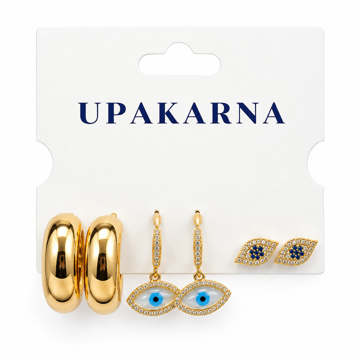 Gold-tone earring set displayed on a white jewellery card, featuring chunky hoops, blue Evil Eye studs, and crystal Evil Eye drop earrings.