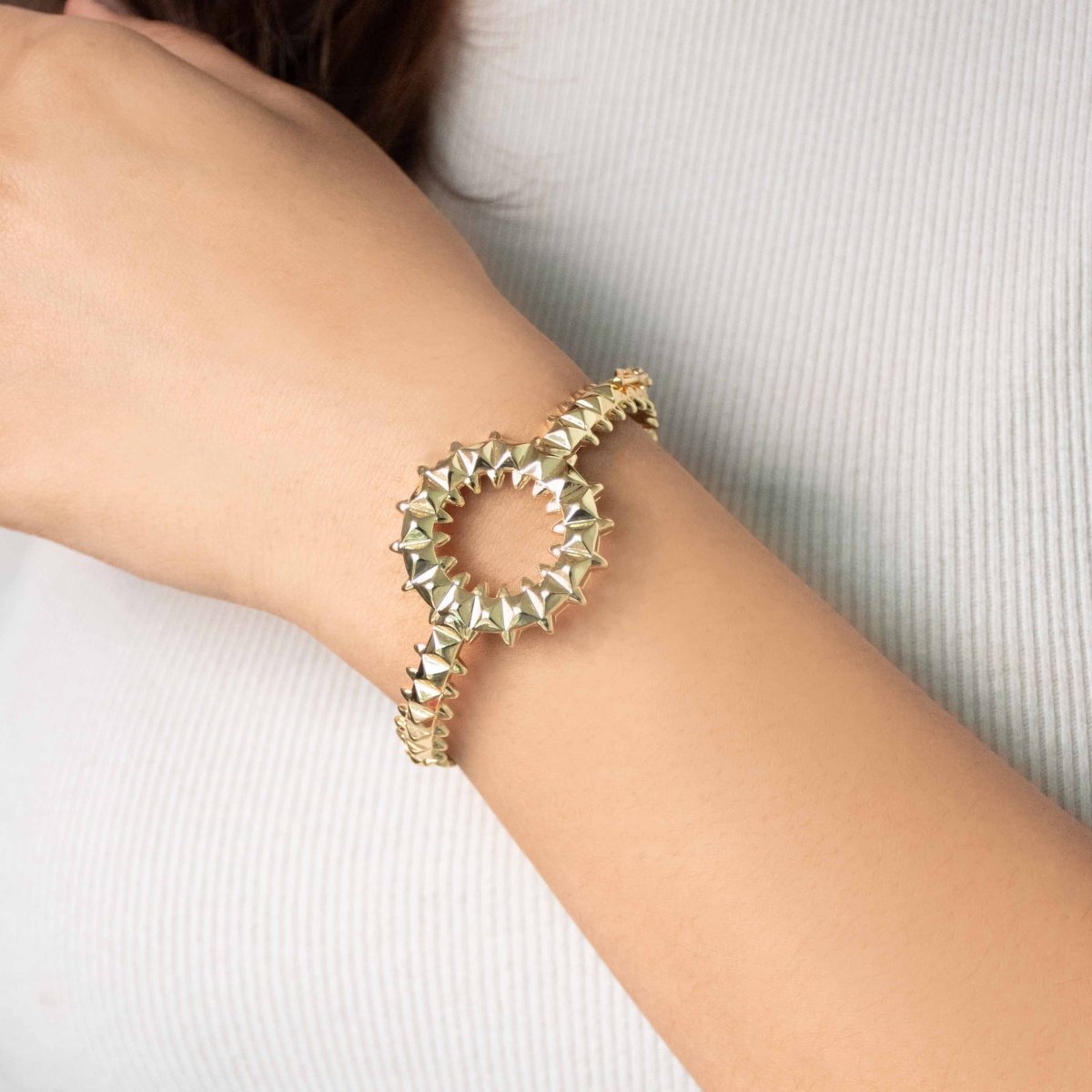 Bold golden spiked-design bangle with an anti-tarnish finish and openable clasp style, perfect for party wear, casual glam, and statement styling.