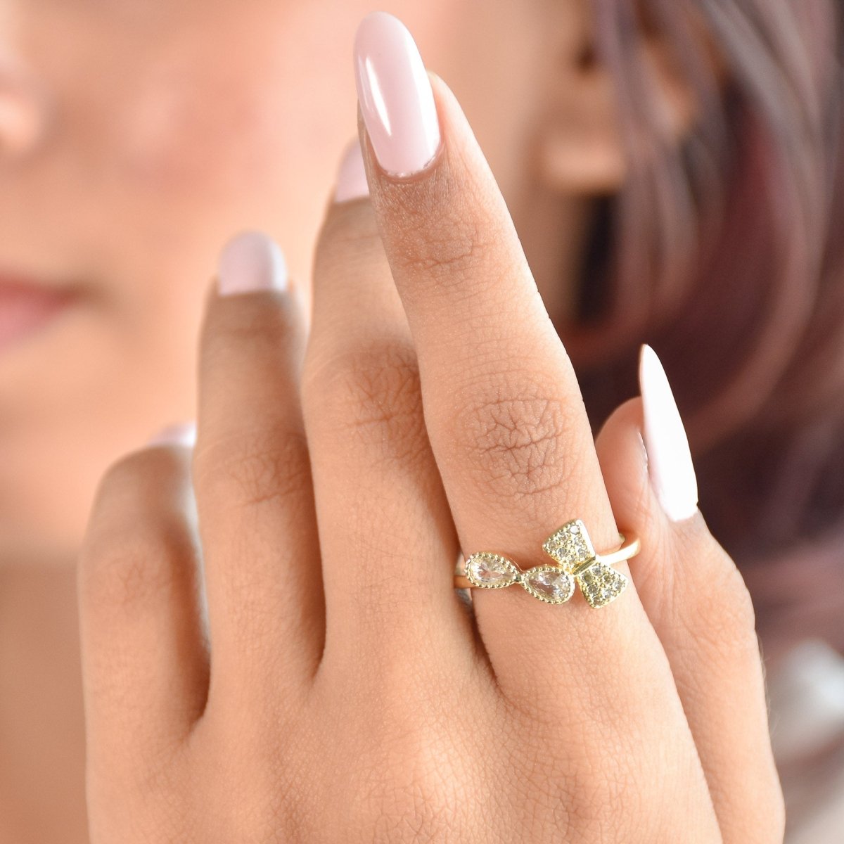 Delicate golden bow ring with sparkling detailing and an adjustable anti-tarnish finish, perfect for everyday elegance, stacking, and chic feminine styling.