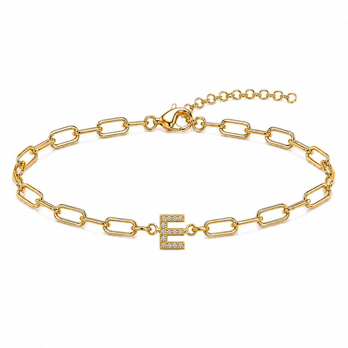 Gold-tone chain bracelet with elongated oval links, a sparkling letter “E” charm, lobster clasp, and adjustable extender chain, displayed on a clean white background.