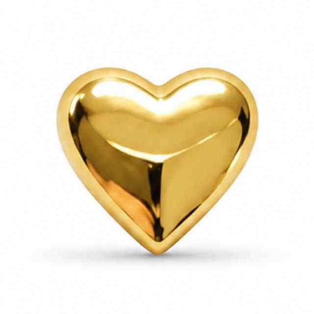 A polished, three-dimensional gold heart isolated against a plain white background. The shiny metal surface features smooth curves and subtle facets that catch light and shadows, giving it a rich, reflective appearance.