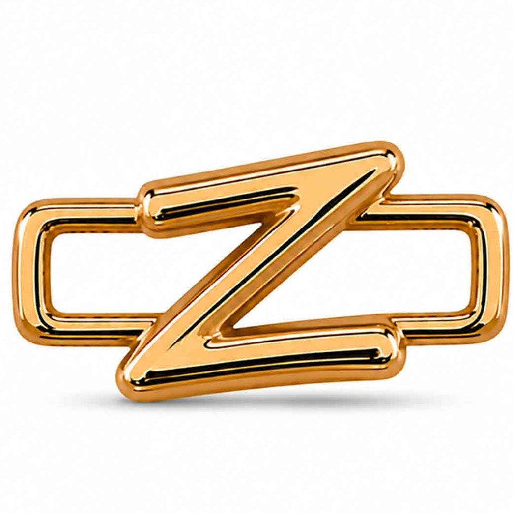 A polished gold-tone letter “Z” charm with a glossy, reflective finish, featuring a bold uppercase A design integrated with a rectangular open-link frame. The charm has smooth rounded edges, a modern minimalist style, and a bright metallic surface, displayed against a clean white background.