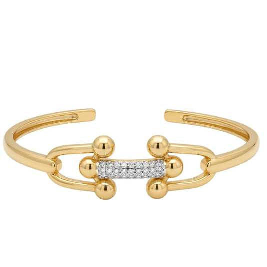 Anti-tarnish gold open cuff bracelet featuring two interlocking U-shaped links with polished ball accents, joined by a central bar encrusted with sparkling pavé cubic zirconia.