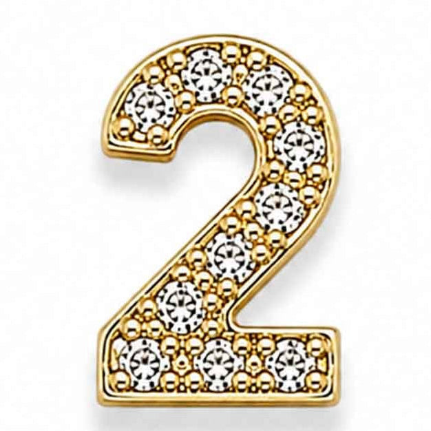 Zoomed-out view of a gold-toned letter “2” charm decorated with sparkling white floral stones, placed on a clean white background.