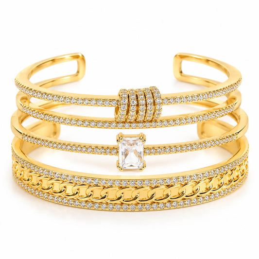 Three gold anti-tarnish bangles stacked together, featuring sparkling pavé crystal detailing, a bold curb-chain design, and an emerald-cut solitaire centerpiece for a premium layered statement look.