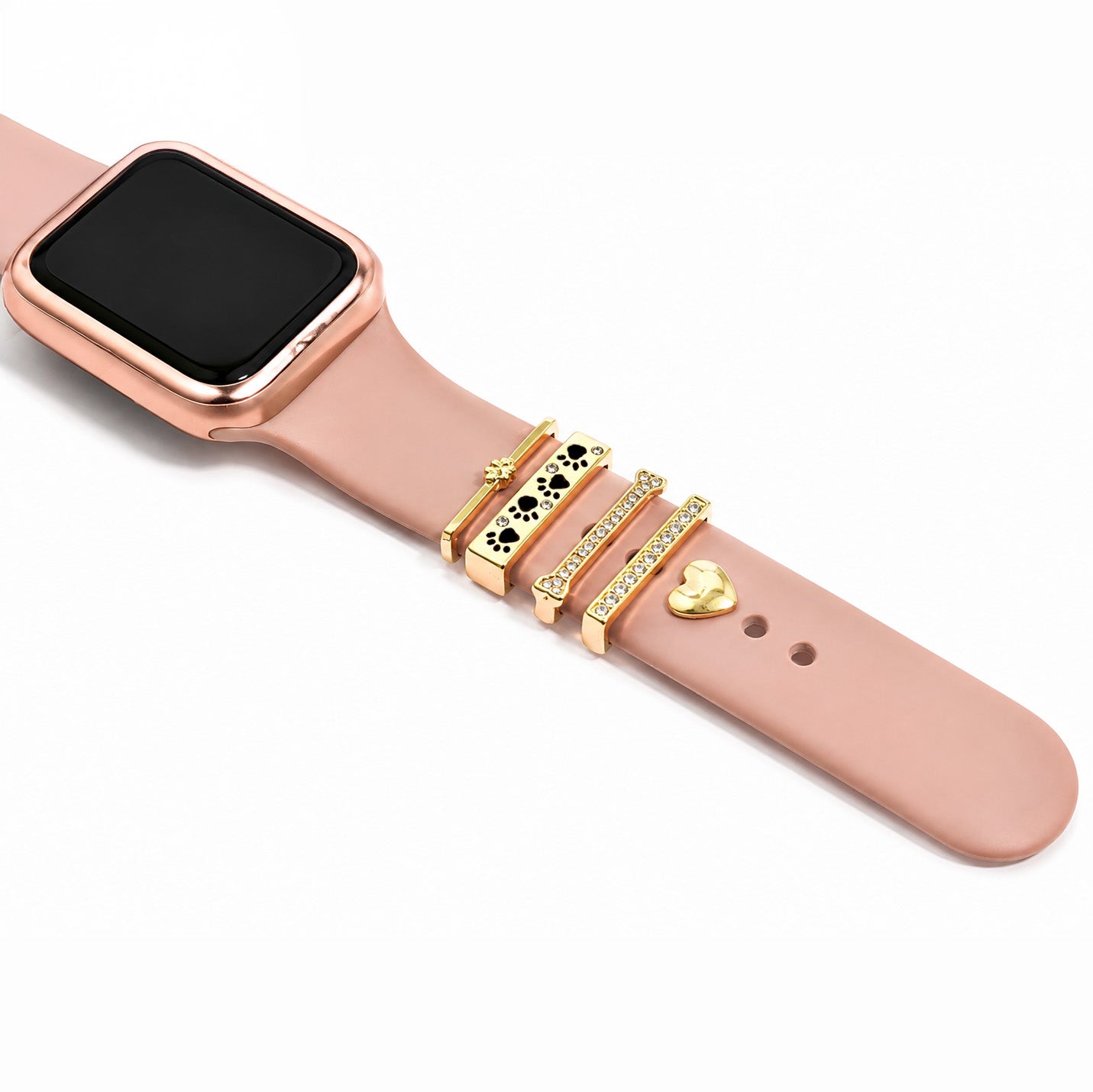 Zoomed-out view of a rose gold smartwatch with a pink strap decorated with gold floral, card-suit, crystal, and heart charms on a white background.