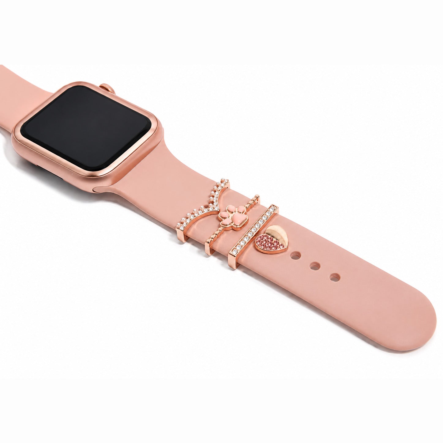 Zoomed-out view of a rose gold smartwatch strap with decorative butterfly, heart and crystal-studded charms on a white background.