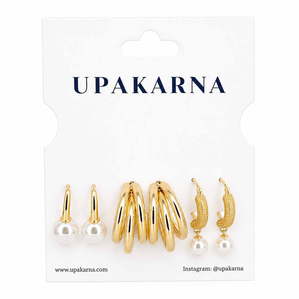 Upakarna gold-tone earring stack featuring pearl stud earrings, layered gold hoop earrings, and textured pearl drop hoop earrings displayed on a branded white jewellery card.