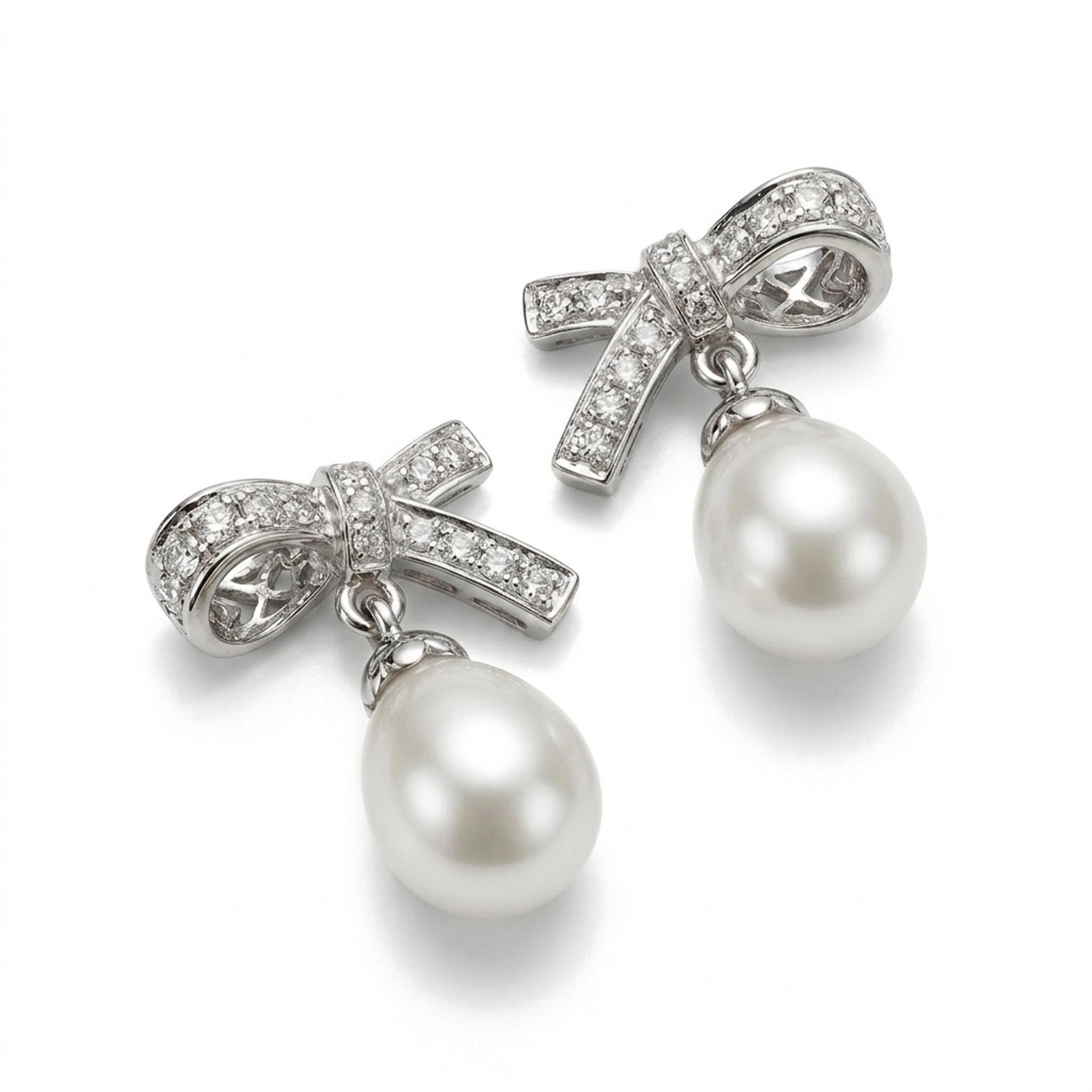 Pearl Ribbon 925 Sterling Silver Earrings featuring sparkling pave-set ribbon bow studs adorned with lustrous teardrop pearl drops