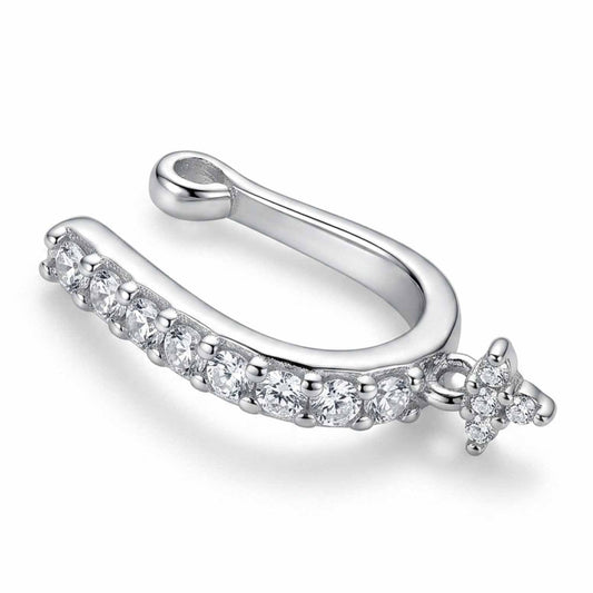 Silver-tone crystal ear cuff featuring a row of sparkling round-cut clear stones along a curved band and a delicate floral crystal accent at the end, with a smooth open cuff design, displayed on a clean white background.